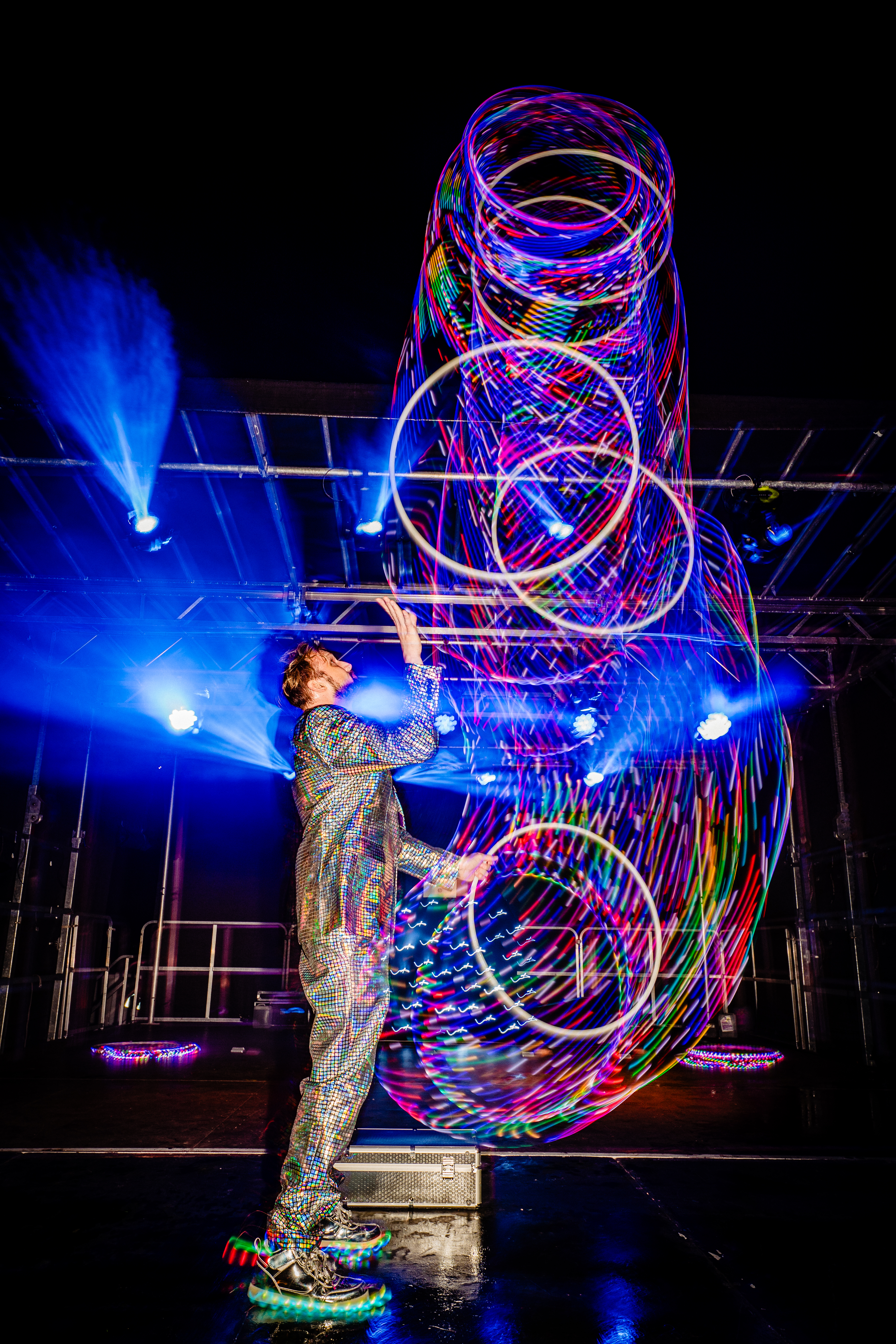 Callum Baker juggling LED hoops with light trails
