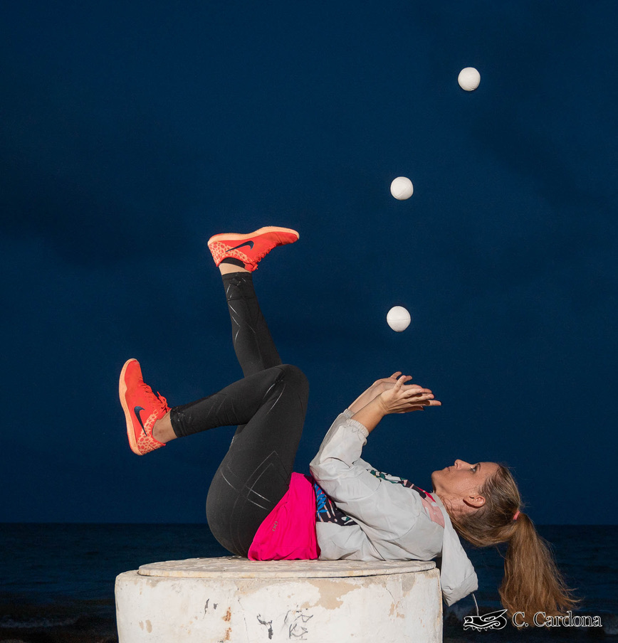 an image of Erin Stephens juggling whilst lying down